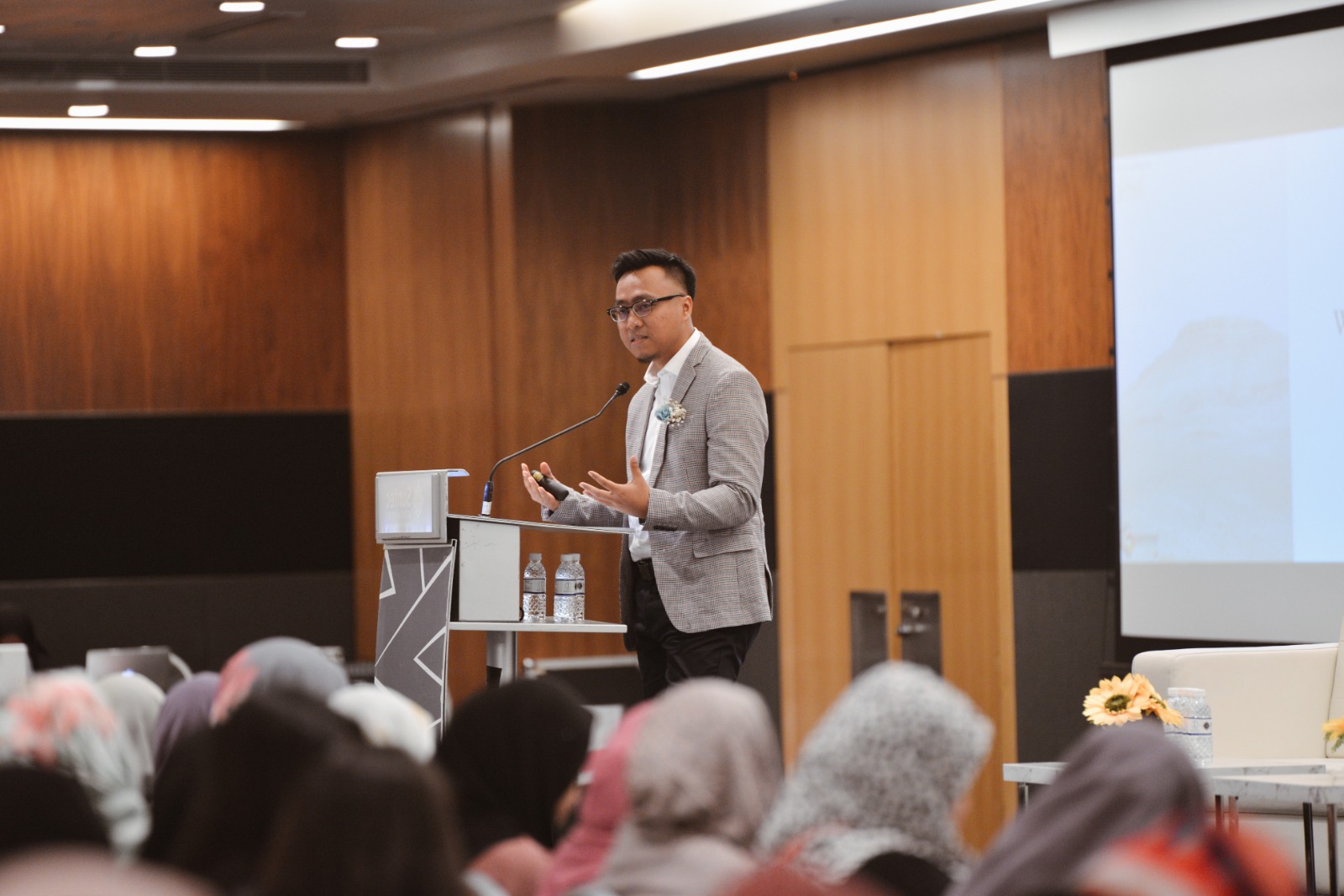 Mizi presenting at a podium
