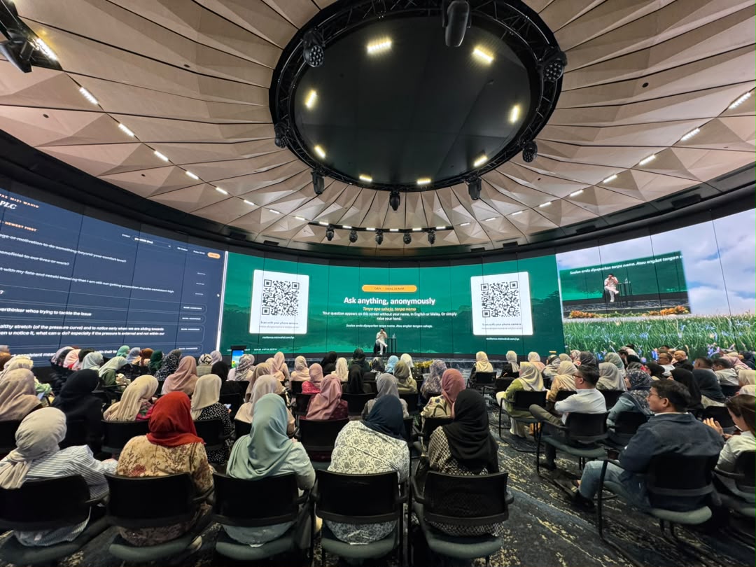 Mizi Wahid addressing a large corporate audience
